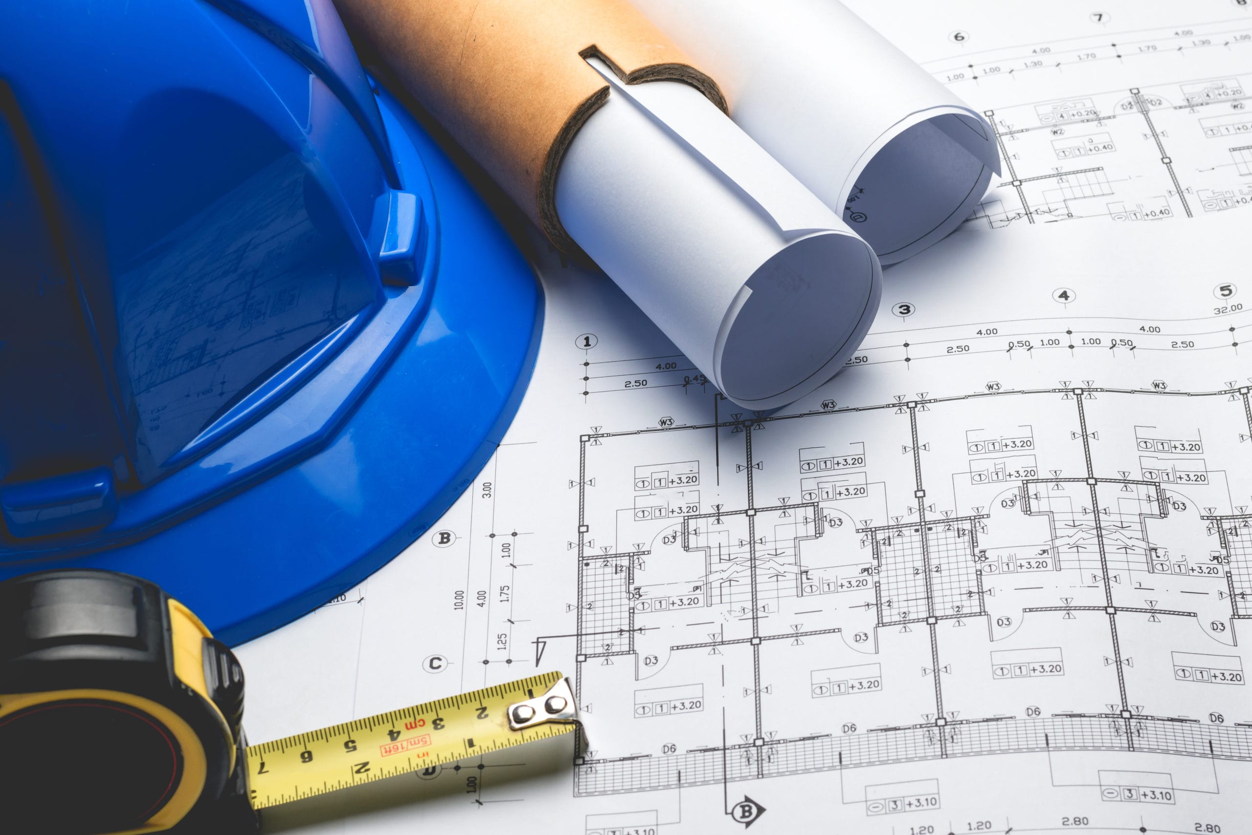 image of a blue hard hat, project plans and ruler